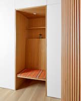 the entrance has a bench / shoe storage niche with a custom cushion covered in Paul Smith fabric  to give a pop of color