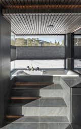 The spa-like bathroom of Casa Myhrer Hauge offers sweeping views of the surrounding landscape. Gudmundur Jonsson Arkitektkontor wanted the design to play off of nature, not encroach on it.