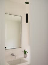 Common powder room with wall hung vanity and toilet, plus a cleaning closet
