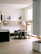 Dining kitchen and living divided by the 3-sided fireplace