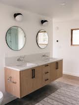 Floating vanities and toilet allow for ease of cleaning