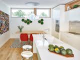 Kitchen, Engineered Quartz Counter, White Cabinet, Medium Hardwood Floor, Pendant Lighting, Ceramic Tile Backsplashe, Recessed Lighting, Wall Oven, Microwave, Undermount Sink, and Cooktops Kitchen and dining  Photo 1 of 11 in 8th and Slocan Laneway House by Lanefab Design/Build