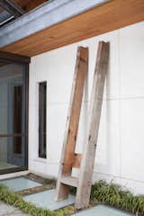 Tall Outdoor Chair -- Made with only four pieces from salvaged douglas fir wood beams, the piece stands at roughly eleven feet tall and leans against the wall