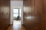 Walk in closet with cabinets by Smith and Vallee Woodworks.