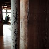 A rough-sawn beam and old pipes create support and structure in the interior of Schoolhouse Electric.