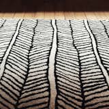 Black and white area rug creates beautiful texture and offsets the warmth of reclaimed wood flooring.  Photo 7 of 10 in Schoolhouse Electric by Jonathan Simcoe