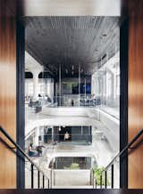 Vertical lines adorn ceilings and columns creating a rhythmic motion to this atrium space.