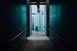 Peering down a dark hallway into cerulean blue green.  Photo 6 of 10 in The Opinionated Leica Q