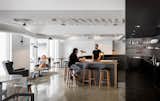 The large circular open bar and the harsh contrasts of black and white makes a dramatic yet engaging place for co-workers to congregate and connect.  Photo 2 of 12 in Step Inside Squarespace’s Minimalist Portland Office