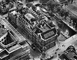 An aerial view of the bank before an expansion in 1927.

The building was originally designed by F.W.M. Poggenbeek in 1908 and was expanded in phases until 1932. The layout follows what would be expected for a bank with vaults on the ground floor and basement, a monumental bank hall on the first floor, and office space located on the upper floors.