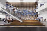 This wall of carefully arranged books at Warby Parker's NYC offices emphasizes their primary brand color in a unique way.