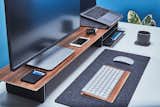 The clean modern lines mixed with dark wool and warm wood tones creates a stunning appearance in any office space.