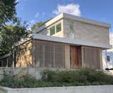 Exterior, Concrete Siding Material, House Building Type, Stucco Siding Material, Stone Siding Material, Wood Siding Material, Flat RoofLine, and Metal Roof Material Street view  showing glimpse of side elevation  Photo 1 of 12 in Old Greenwich House by Sellars Lathrop Architects