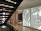 Staircase, Metal Tread, Glass Railing, and Wood Tread Coming up the stairs from lower level . Tatami room in distance.  Photo 6 of 12 in Old Greenwich House by Sellars Lathrop Architects