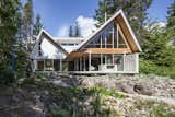 From the back of the house the view is across a pond surrounded by a wildflower meadow and on to woodlands with mountains and the Black Tusk peak beyond.  Photo 13 of 16 in Whistler Cabin by Derek Lepper