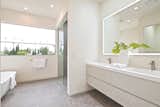 Master bathroom with palm tree lined ocean views. Custom Sinks by Furgeson, Flooring by Porcelenosa.