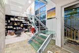 Bold, all glass staircase that links all three levels of the home. Allowing natural light to pour through the home.