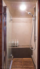 The shower features a teak grated floor and thermostatic shower valve that always starts at the same temperature it was last set to. 
