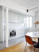 Kitchen, Light Hardwood Floor, Marble Backsplashe, Pendant Lighting, Wall Oven, and Cooktops Open kitchen-dining area. Hubert by Septembre. © David Foessel.

upinteriors.com/go/sph18  Photos from Old-World Charm Meets Modern Finishes in These 6 Parisian Apartments