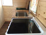 Another view of the kitchen counter under work with the sink exposed.