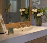 La Cava sink and matte white vanity top sits over oak cabinet.