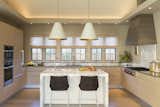 Because it is open to the great room the kitchen is designed with a tailored demeanor.  A bank of windows over the sink bathes the space with soft, north facing natural light.