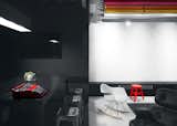 Dark gray and white surface dictate a balance that is brightened by deliberate accents.