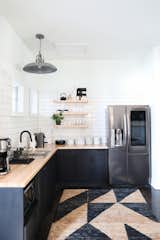 Kitchen, Ceiling, Wood, Refrigerator, Wood, Concrete, Drop In, Subway Tile, and Microwave Open shelving, subway tile, a geometric rug, butcher block counters - what's not to love?  Kitchen Microwave Drop In Wood Refrigerator Wood Subway Tile Photos from Southside Creative's New Studio