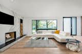 Living Room, Wood Burning Fireplace, and Light Hardwood Floor  Photo 4 of 10 in Modern Renovation by smpl Design Studio