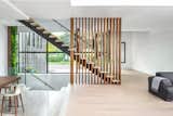 Staircase, Wood Tread, and Glass Railing Slatted wall stairs  SMPL Design Studio’s Saves from The Clifton House