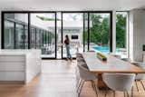 Dining Room, Chair, Ribbon Fireplace, Light Hardwood Floor, Recessed Lighting, and Table Opening to the outdoors for the nice weather !!  Photo 10 of 12 in Miami Modern by smpl Design Studio