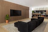 cozy tv room and office space, with wood slat walls and hidden pocket doors finished to match