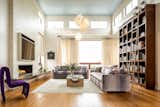 Living Room, Bookcase, Chair, Pendant Lighting, Sofa, Coffee Tables, Medium Hardwood Floor, and Gas Burning Fireplace 25ft ceilings in the great room, linear gas fireplace, library shelving and Frank Gehry Cloud pendants.   Photo 6 of 17 in Xanadu by Spaces CT