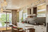 Kitchen, Granite Counter, Accent Lighting, Range Hood, Cooktops, Marble Counter, Pendant Lighting, Metal Backsplashe, Undermount Sink, Metal Cabinet, and White Cabinet Boffi kitchen cabinetry, red fire granite, zinc backsplash and Miele appliances.   Photo 7 of 17 in Xanadu by Spaces CT
