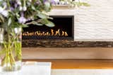 Linear gas fireplace by Acucraft. Porcelanosa waves tiles. Golden Kosmus granite. 