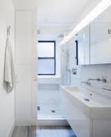 A wall mounted vanity,  glass enclosed shower and built in cabinets seek to maximizes the feeling of space within a very tight footprint.  Photo 3 of 7 in Bathroom by Christine Ostler Palmer from Prewar Modern Upgrade