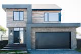 Exterior featuring stone by Cultured Stone, barn siding locally sourced, manufactured and treated as well as grey siding by Good Fellow