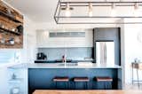 Modern kitchen with quartz counters and backsplash by Ceasarstone and stool by Structube.