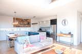 Great view of the dining room and kitchen with custom barn wood  frame and steel shelves.