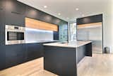 Black PET and white oak cabinets, faucet by KOHLER, pot fillet by BLANCO, oven and range by BOSCH