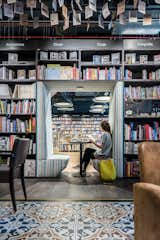 Dividing wall between bookstore and café is perforated by niches wich are basicaly places for relaxing and reading.