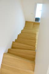 Staircase, Wood Tread, and Metal Railing Deatil of staircase.  Photo 16 of 27 in Rhapsody in White  / Attic by AT26  architects