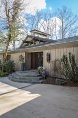 The main entrance. The shape of the chimney cap is a defining architectural feature that Schechter used on her addition as a nod to the original architect.  Photo 3 of 13 in Mid-century Modern Gathering Space by Kim Weiss