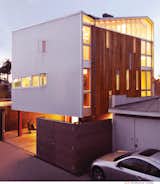Venice House at dusk. Interior and exterior lights bathe the modern house in a warm glow.