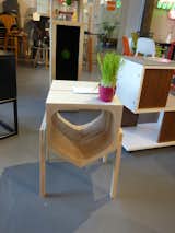 Cat House/Modern Side Table by Corey Baughman of Clearscapes. The piece is composed of solid maple and brass with a painted light-blue exterior and wax finish. The inverted form is reminiscent of a traditional concept of “house.” The interior is carved. The exterior is smooth. And elevated on tapered legs, it can serve as both cat house and modern side table. There’s also a cup holder on the surface.