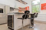 The extended countertop on the island provides a casual dining option and lets guests watch the cook at work. A wine cooler is tucked into one end of the island.