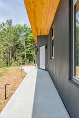 A simple cement walkway leads from the garage to the front door and mirrors the angle of the entrance.