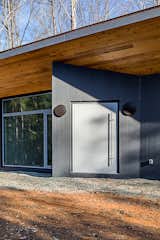 The angular entrance draws attention to the steel pivoting front door.