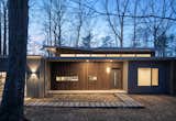 Exterior, Metal Roof Material, Butterfly RoofLine, Flat RoofLine, House Building Type, Concrete Siding Material, Wood Siding Material, and Green Siding Material The main entrance.  Photo 4 of 11 in The Wolf-Huang House by Kim Weiss