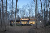 Exterior, House Building Type, Metal Roof Material, Flat RoofLine, Green Siding Material, Butterfly RoofLine, Concrete Siding Material, and Wood Siding Material The lake-side elevation  Photo 5 of 11 in The Wolf-Huang House by Kim Weiss
